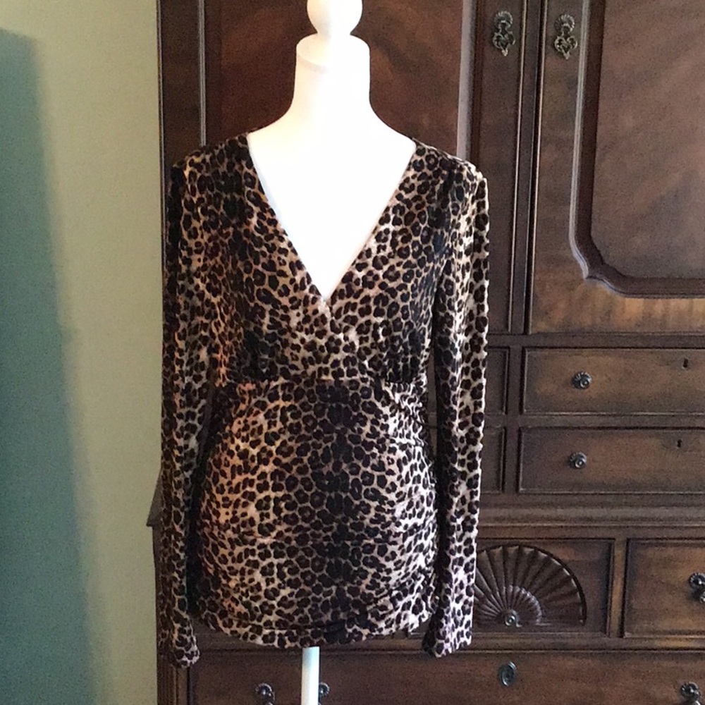INC leopard print crossover style. Stretch, form fitting fabric. Shirred sides.